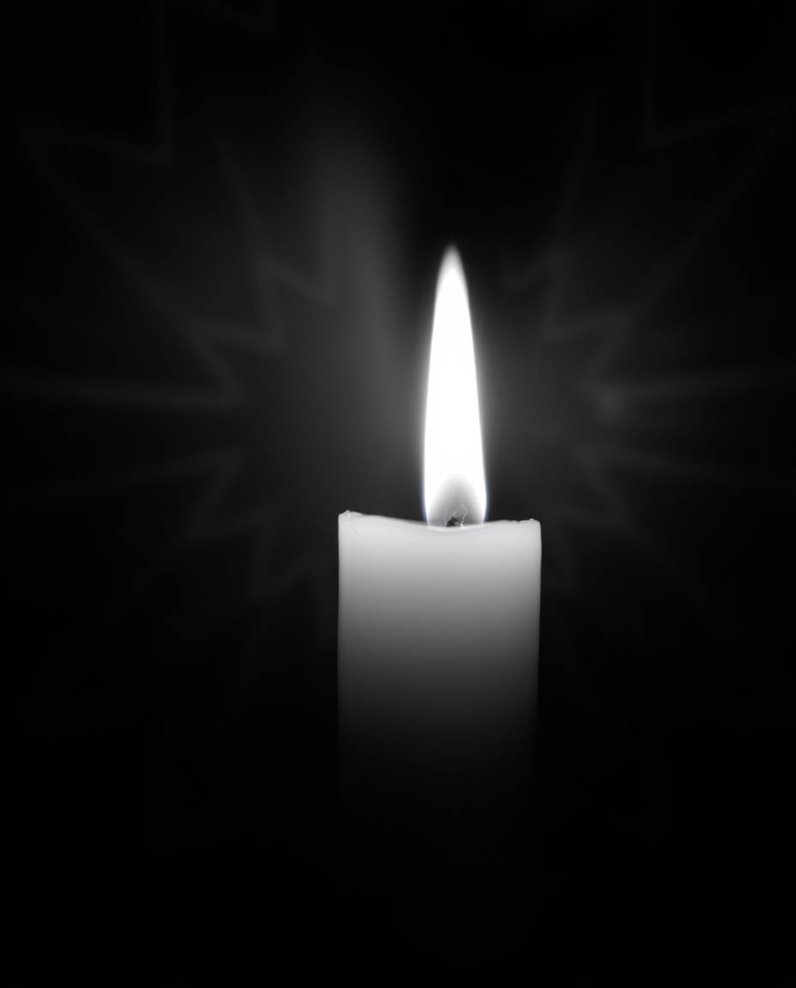 Capture the essence of a dreamy atmosphere with warm candlelight illuminating a black and white geometric optical illusion pa