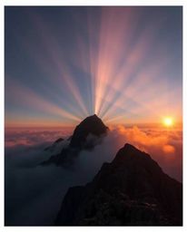 This is a high-quality fine art photograph capturing a breathtaking sunset from a high alpine peak. The image beautifully sho