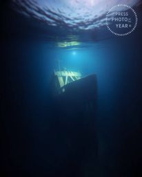 This series showcases professional photographs of a shipwreck illuminated in the deep underwater. The images feature divided 