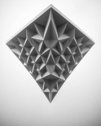 Explore the intriguing world of 3D geometric patterns resembling folded paper in stunning monochrome architectural photograph