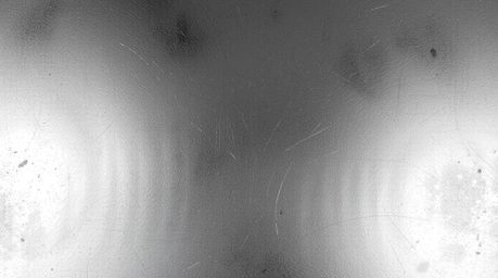 A classic black and white image showcasing a cast bronze surface with an iridescent gradient texture. The vibrant color shift