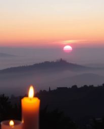 Experience a soft pastel sunset over the misty, rolling hills of Tuscany, where a warm candlelight glow casts a gentle and so