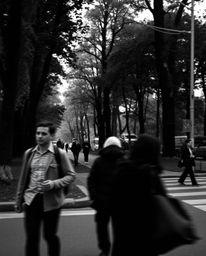 This classic black and white candid street photograph showcases a captivating digital glitch effect superimposed over an urba