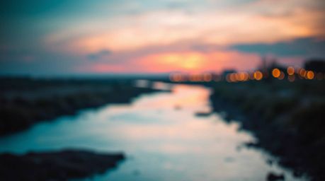 Capture the serene beauty of a river delta bathed in the warm glow of twilight, where terracotta hues meet cool teal tones.  
