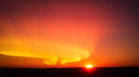 Capture the ethereal beauty of bioluminescent Northern Lights emerging over a breathtaking sunset sky in this fine art photog