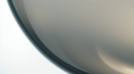 Explore captivating close-up visuals of glass objects reflecting smooth gradient textures in a soft cinematic style. Low cont