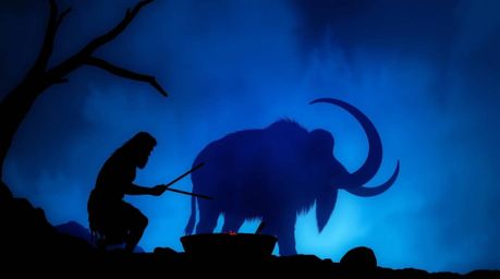Imagine a stunning scene of a silhouetted caveman expertly cooking mammoth meat, brought to life with a cool color palette do