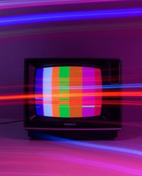 A captivating long-exposure photograph showcases the mesmerizing motion trails of a retro-style TV screen glitch, featuring v