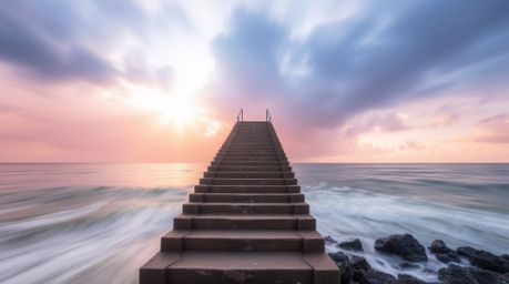 A captivating long-exposure photograph depicts a dramatic staircase rising from the ocean towards a stormy sky illuminated by