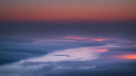 Experience the serene beauty of a river delta bathed in the soft, pastel hues of twilight. Volumetric lighting dances through