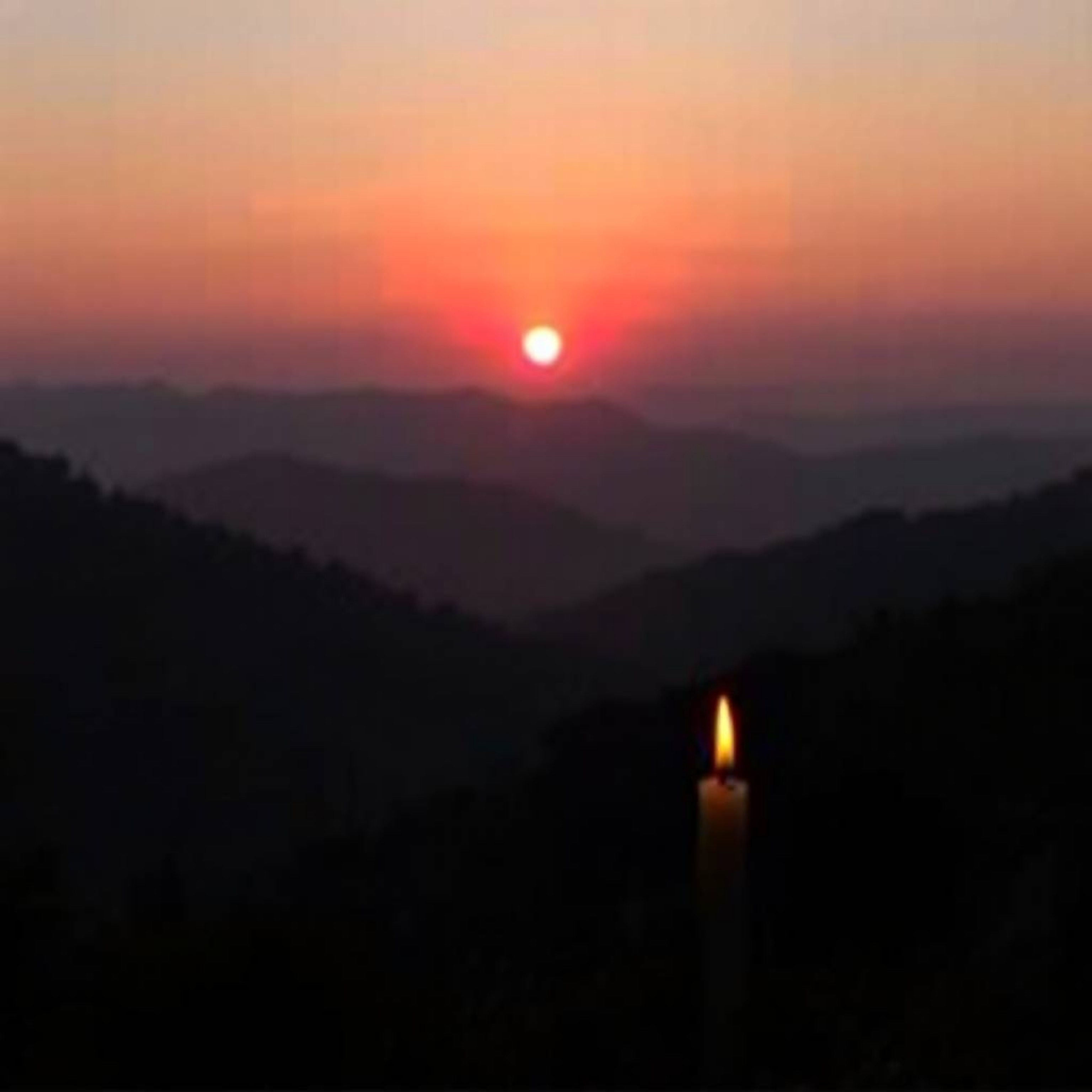 Experience the tranquility of a sunset over a quiet mountain valley.  Warm candlelight illuminates the scene, creating a smoo
