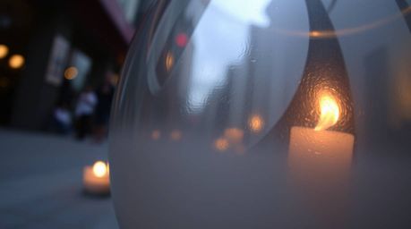 Explore the captivating world of candid street photography with a low-angle perspective, showcasing a glass object reflecting
