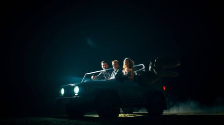Experience a visually stunning scene featuring a prehistoric family riding a dinosaur car, brought to life with intense drama