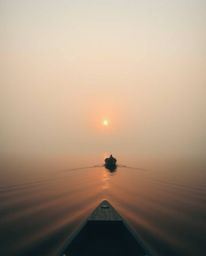 A boat drifts on a lake at sunset, captured in a beautiful cinematic style. The scene is bathed in a unique palette of warm t