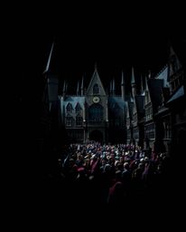Explore a captivating and intensely jet-black image of a magical school teeming with young wizards. The pure black background