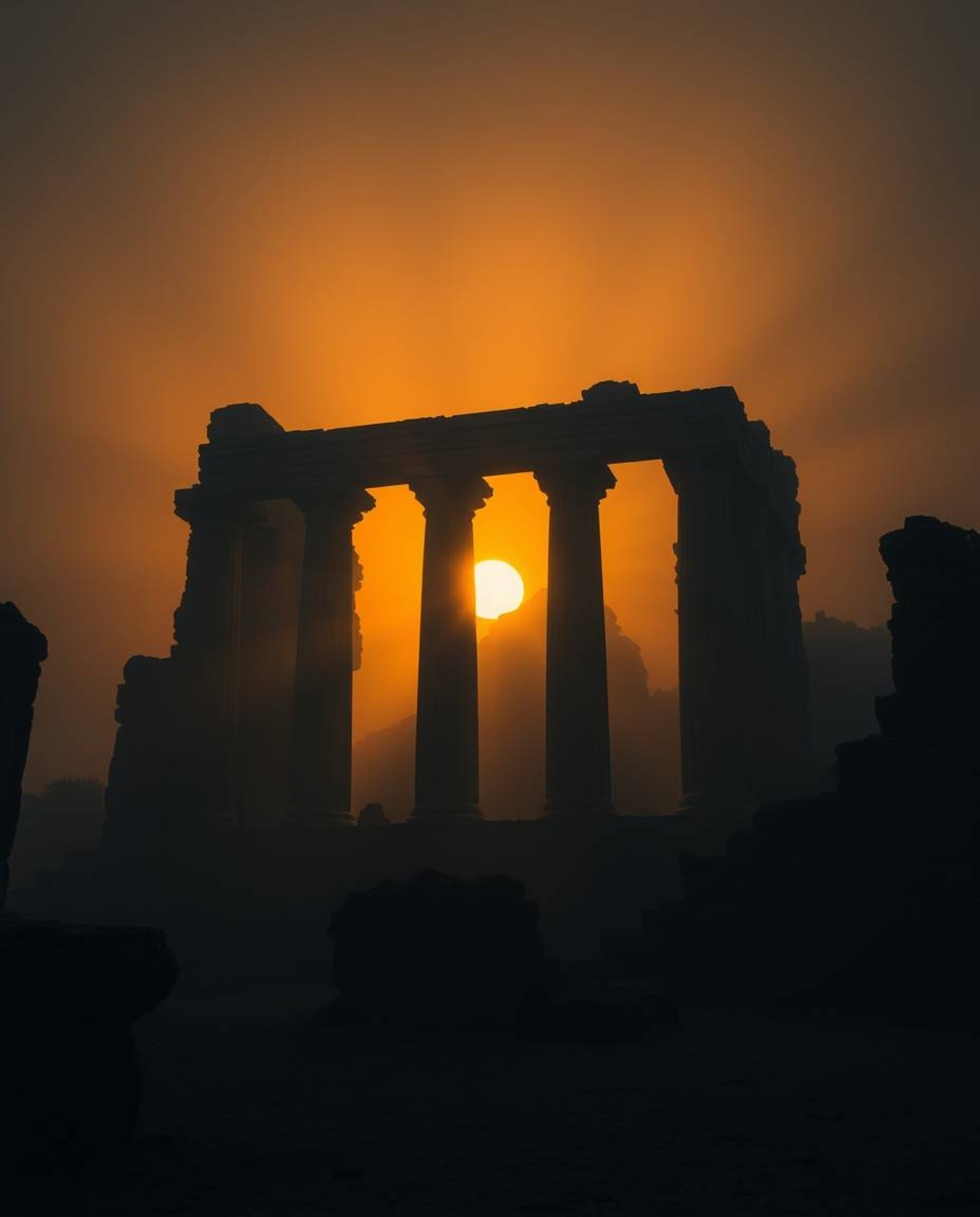 Witness the dramatic effect of volumetric lighting illuminating ancient stone ruins at sunset, casting eerie shadows that sli