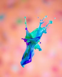 Explore stunning visual art featuring cool color blurred bokeh effects and vibrant, frozen paint splashes captured mid-air.  