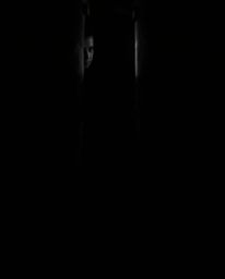 A captivating black and white photograph featuring chiaroscuro lighting, creating a dramatic contrast between light and shado