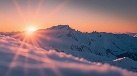 An extreme macro photograph captures the breathtaking beauty of snow-covered mountains bathed in the soft glow of a pastel su