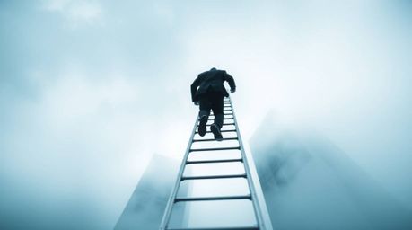 This striking black and white macro photograph captures the abstract concept of success. A businessperson ascends a transpare
