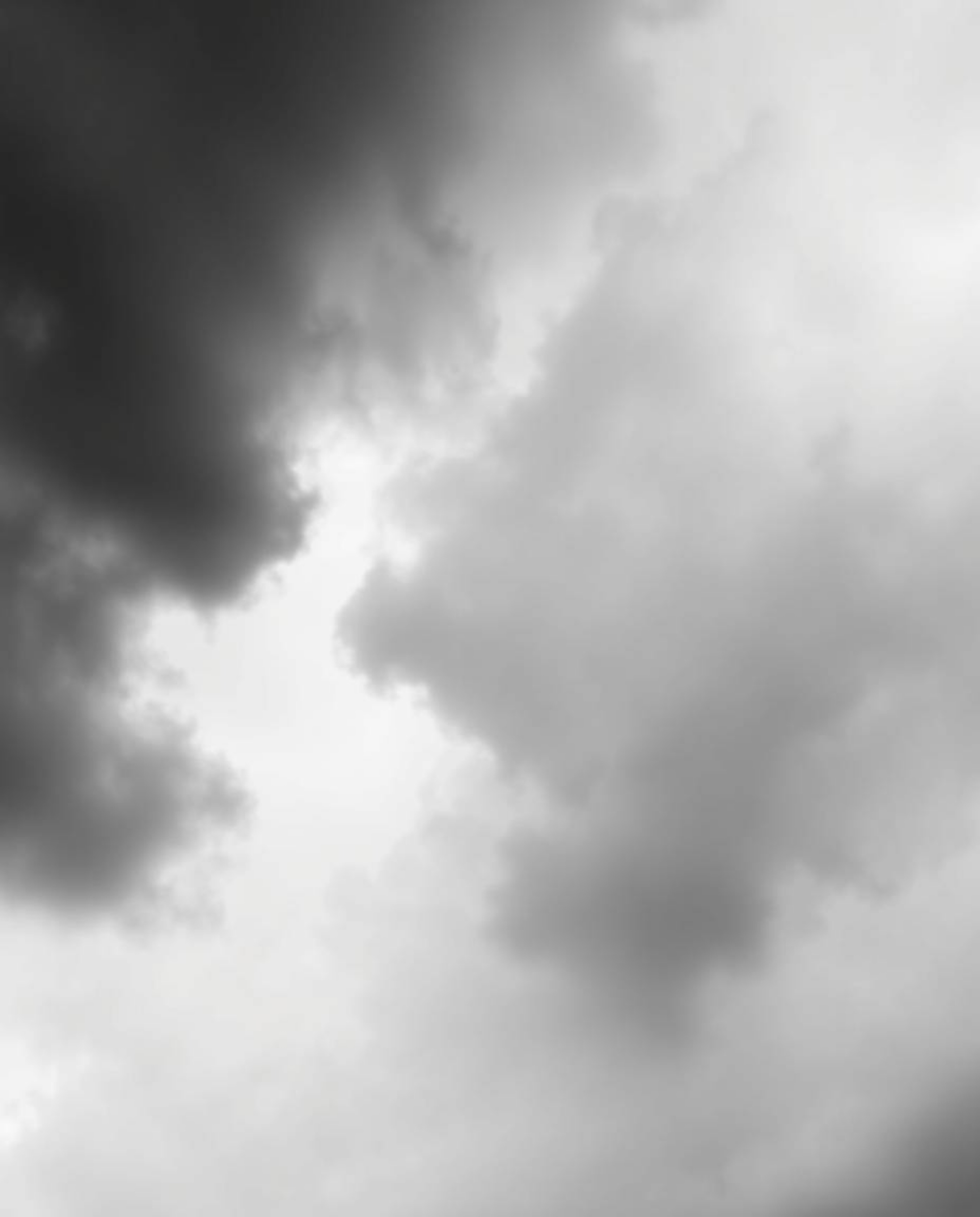 A classic black and white photograph depicting intense dramatic weather. Stormy skies create high tension, contrasted by a ti