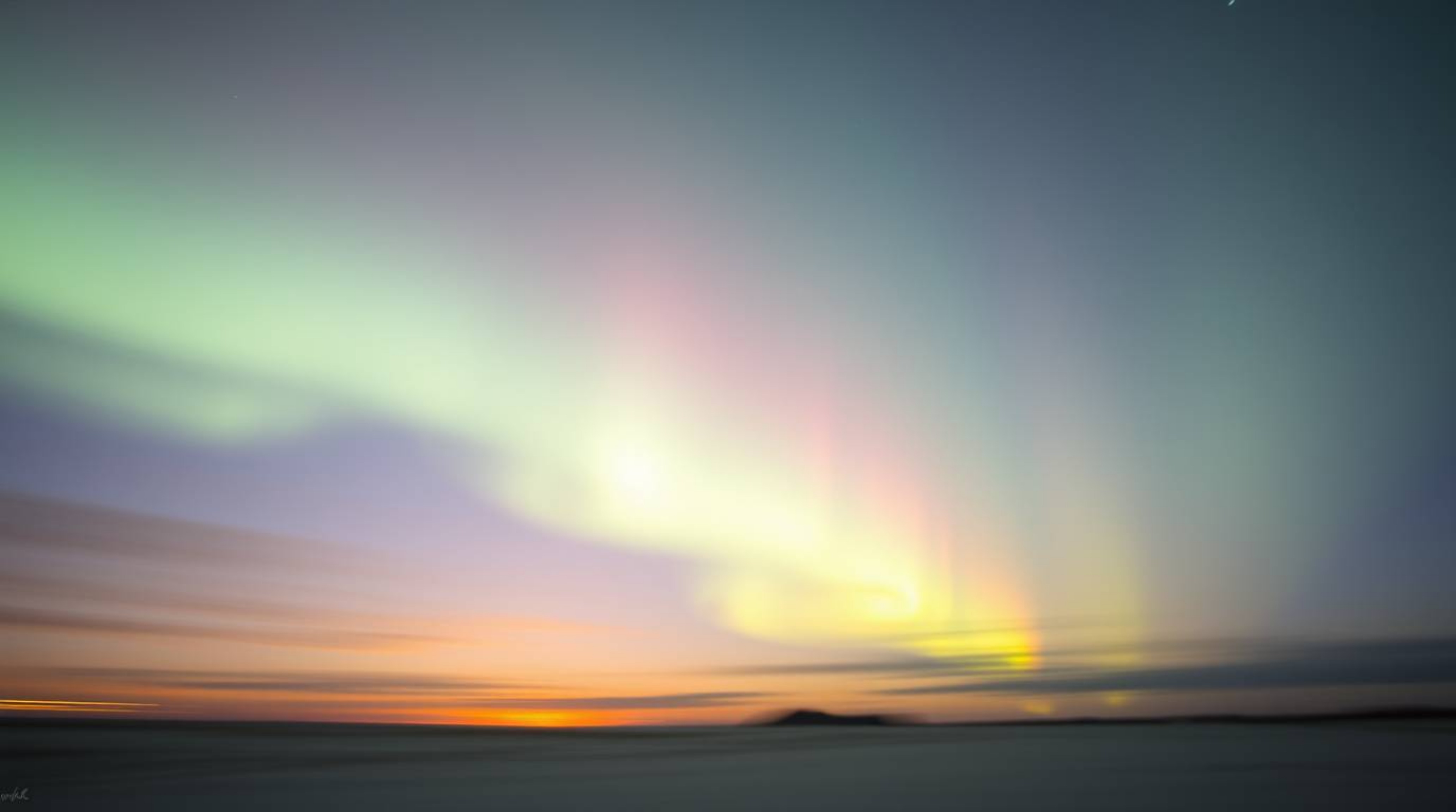 Capture the ethereal beauty of the Northern Lights with this stunning long exposure photograph.  Soft pastel hues paint the s