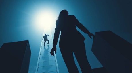 A captivating image depicts a strong, moody silhouette of a graceful businessperson ascending a transparent ladder that disap