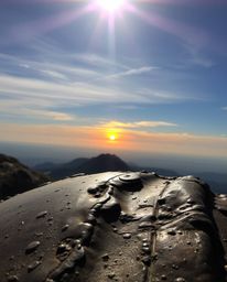Witness a sunset from a high alpine peak reimagined with a unique bronze patina finish. This piece features strong, hard ligh