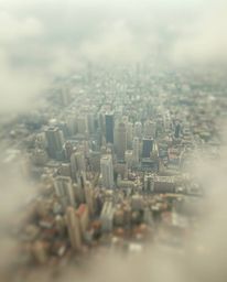 A stunning abstract city map rendered in soft, cinematic haze.  Viewed from above, the image features geometric shapes with a