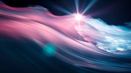 A captivating cinematic photograph showcases a fluid abstract wave with a mesmerizing pastel gradient texture.  Vibrant color
