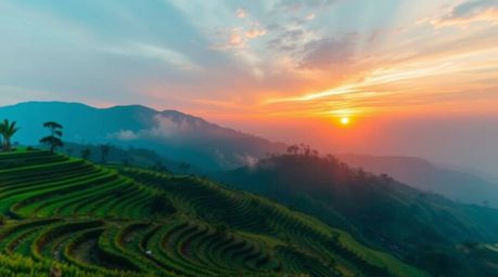 Experience a breathtaking sunset over mountain rice terraces, captured in a soft cinematic haze. The bright, lively colors do