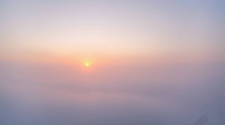 Experience the serene beauty of a sunset over icy glaciers in a polar region.  This breathtaking scene features soft pastel c