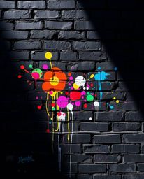 Discover stunning high-contrast images of intense jet-black graffiti art splashed across a brick wall. This vibrant street ar