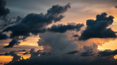 Capture the dramatic beauty of thunderstorm clouds illuminated by the warm glow of sunset. This dreamy photograph utilizes co