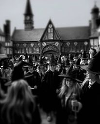 A classic black and white image showcases a magical school brimming with young wizards. The background is beautifully softene