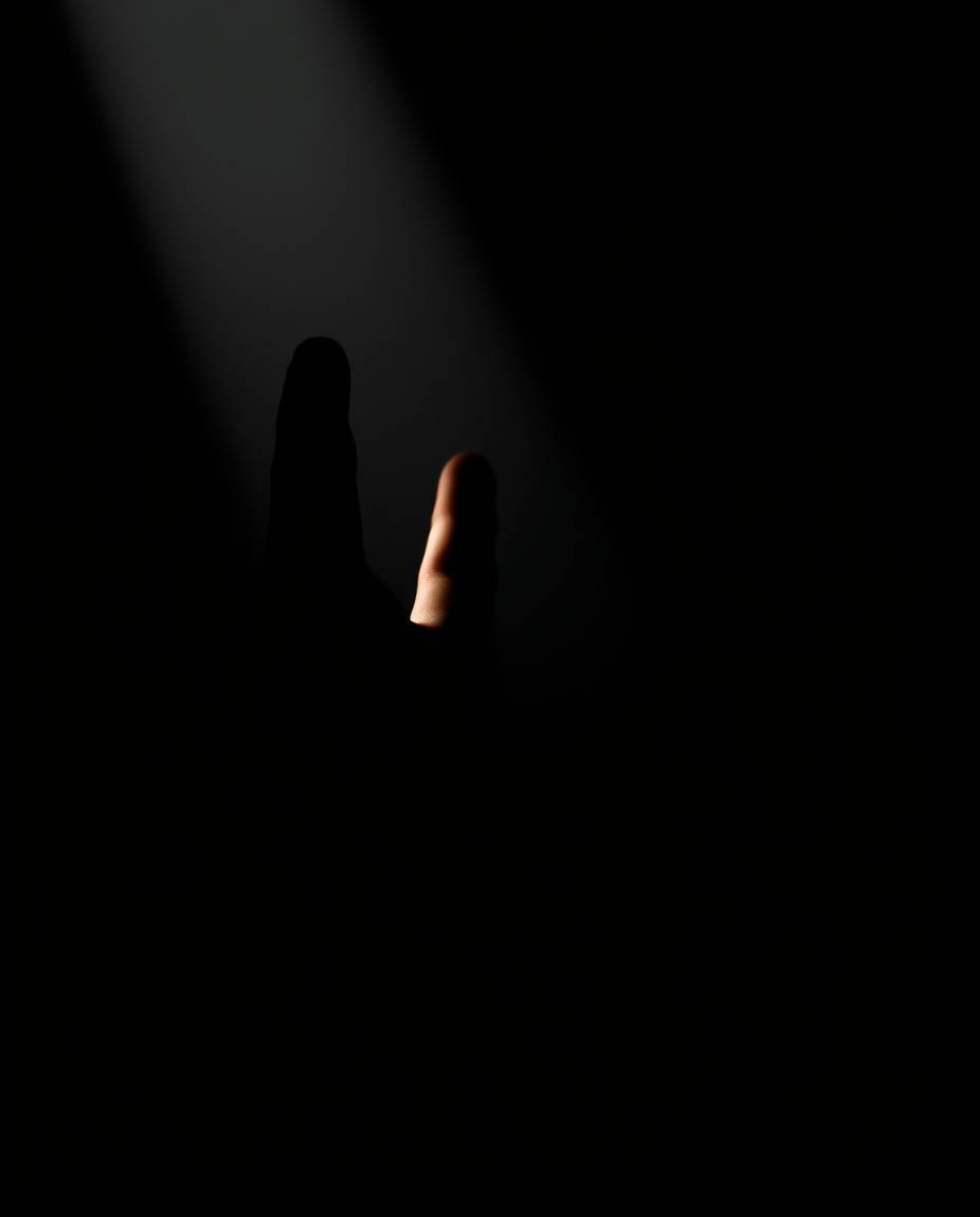 A captivating image featuring a hand reaching towards the light from the depths of darkness, rendered with striking chiaroscu