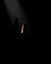 A captivating image featuring a hand reaching towards the light from the depths of darkness, rendered with striking chiaroscu