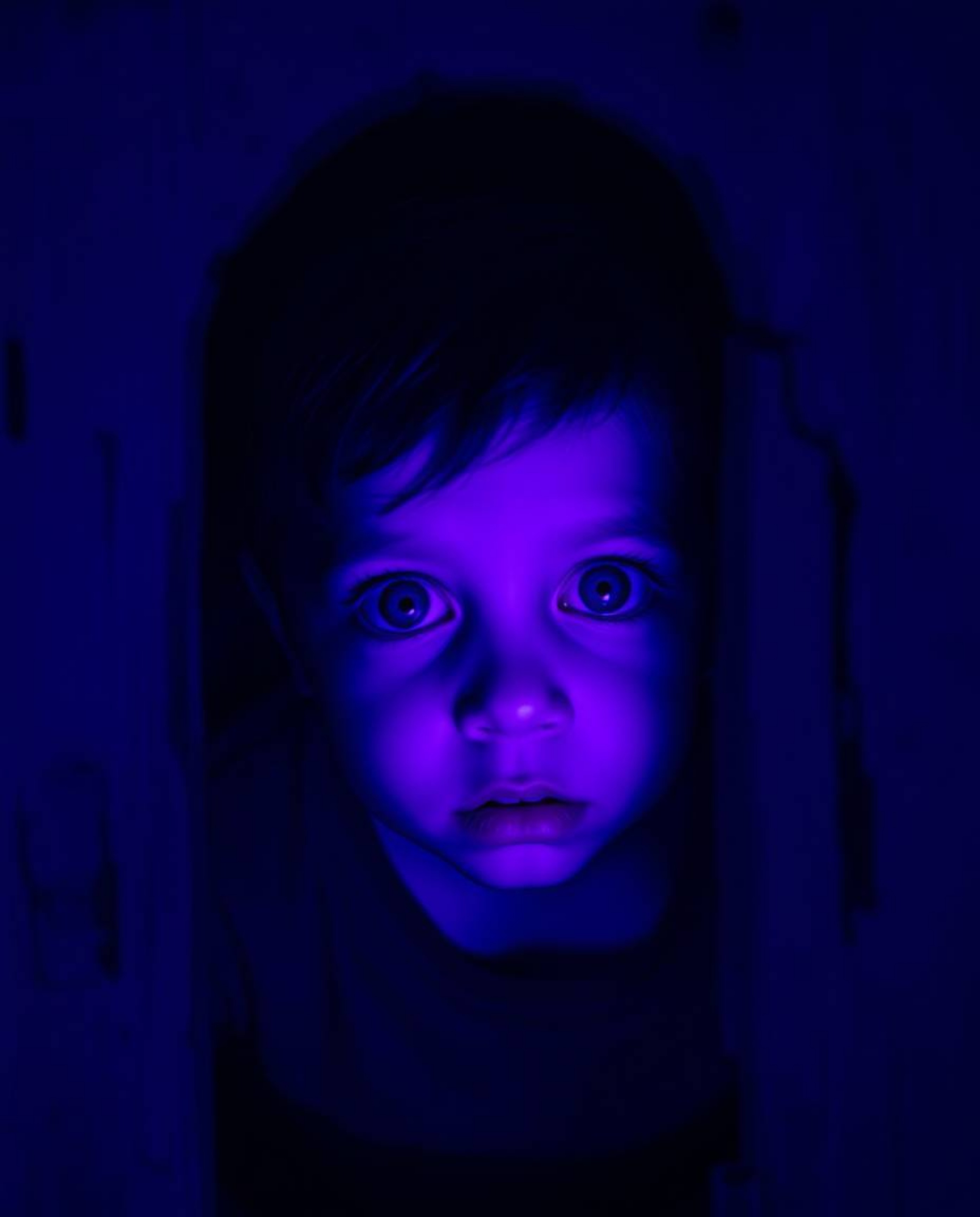 A young child stumbles upon a mysterious portal hidden in their backyard, bathed in eerie deep ultraviolet hues.  The scene i