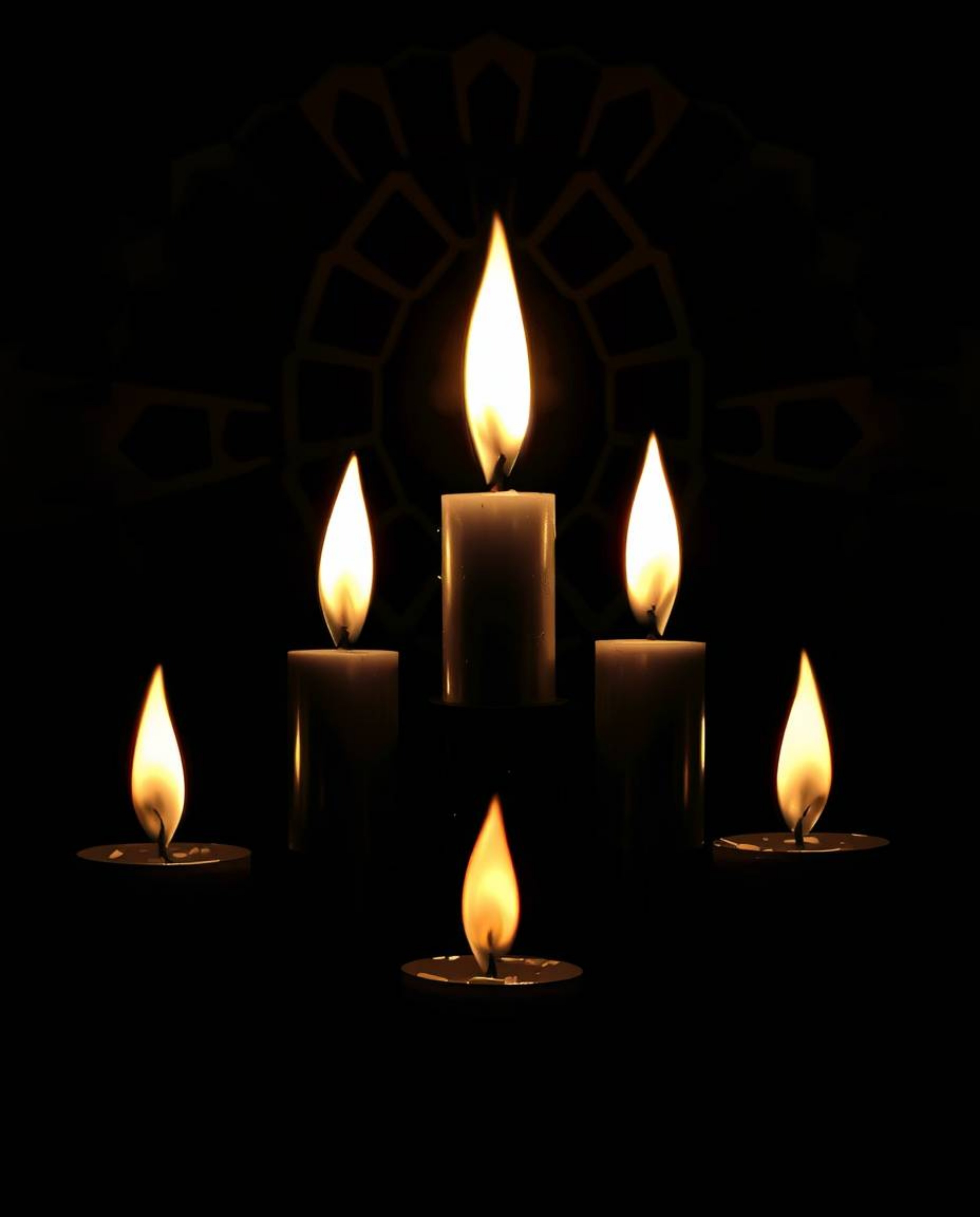 An intense black and white image featuring warm candle lights creates a mesmerizing geometric optical illusion with retro vib