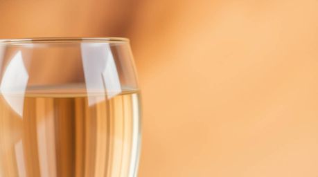 Explore the beauty of natural earth tones captured with a blurred bokeh effect, highlighting a glass object reflecting smooth