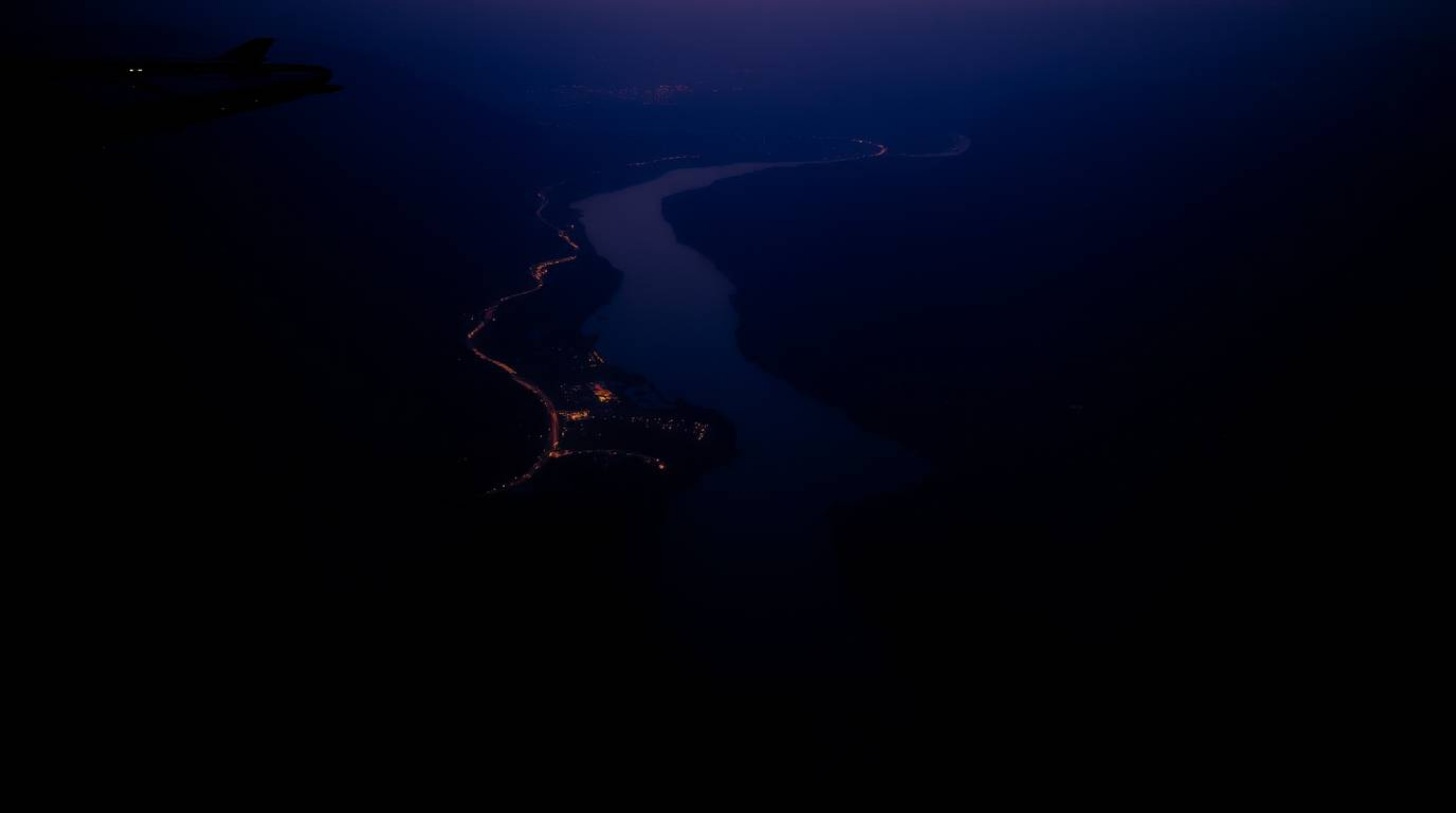 A captivating image of a river delta silhouetted against a twilight sky.  Strong backlighting enhances the dramatic shapes an