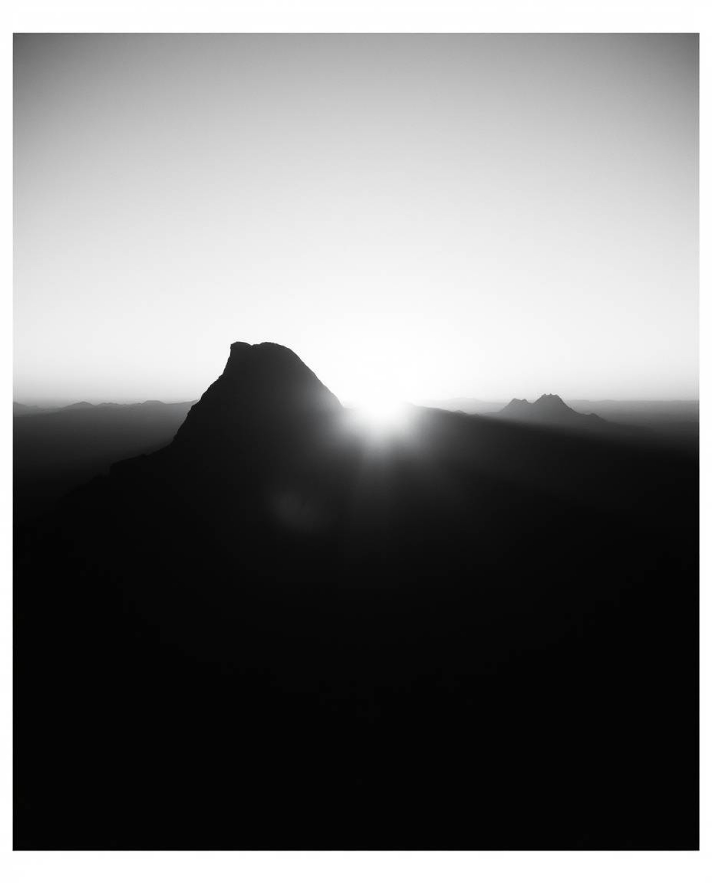 Embrace a timeless, elegant aesthetic with this classic black and white cinematic style depiction of a high alpine peak sunse
