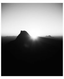 Embrace a timeless, elegant aesthetic with this classic black and white cinematic style depiction of a high alpine peak sunse
