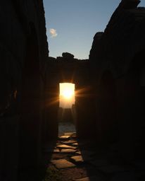 A moody yet adorable style captures sunset shadows falling through ancient stone ruins. This artwork features charming detail