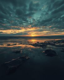 This artwork features a cast bronze surface depicting a sunset sky mirrored in tidal pools, creating an eerie and creepy atmo