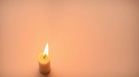 Experience the serene beauty of warm candlelight set against an abstract gradient background with a delicate paper grain text