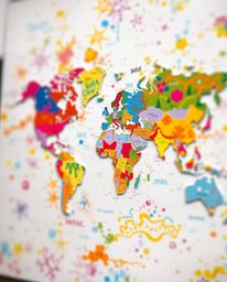 This artwork features a vibrant world map crafted from layered papier-mâché and rendered with bright, colorful splashes.  The
