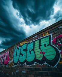 Capture the intensity of dramatic weather with this stunning image. Featuring vibrant, graffiti-style splashes on a textured 