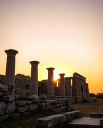 Capture the timeless beauty of ancient stone ruins with this high-resolution stock photograph, taken at sunset during the war