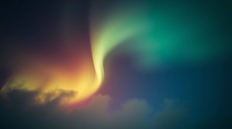 Capture the mesmerizing beauty of the Northern Lights dancing above a sunset sky with a soft cinematic haze. This low-angle p